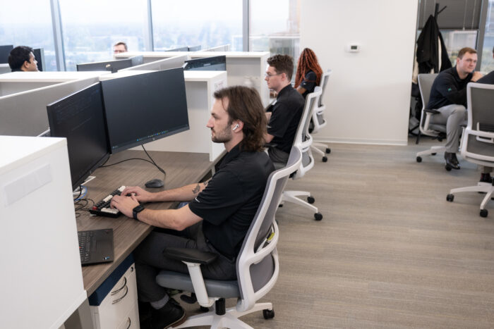IT - Desk Shot of Employees Working Horizontal